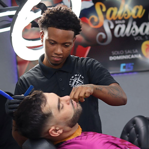 barber grooming customers beard